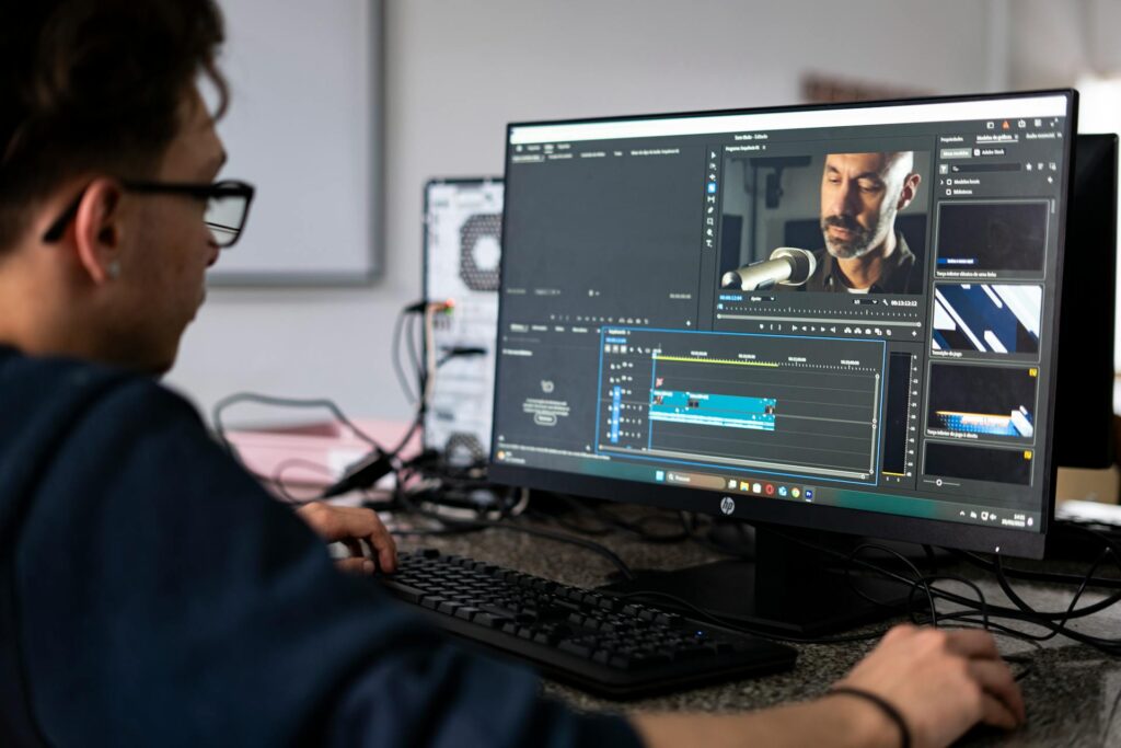 A video editor working on footage at a computer
